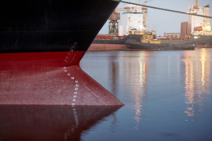 Draft marks ship waterline numbers bow stern vessel seaport evening