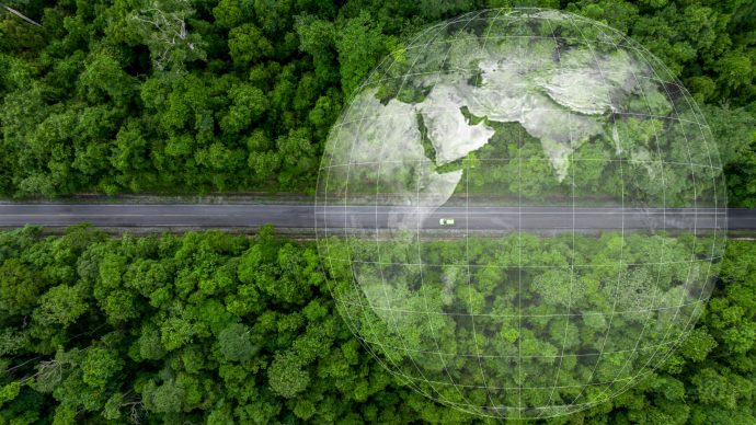 Aerial top view green electric vehicle car driving straight forest road ev car electric